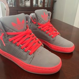 Adidas high top sneakers. They are grey and hot pink.